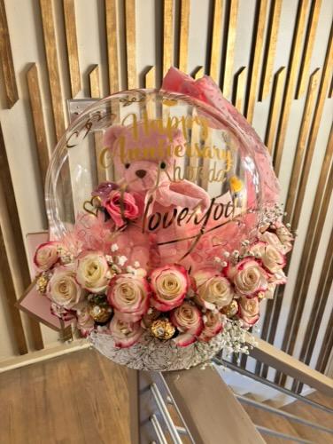 Teddy bear stuffed balloon with fresh flowers